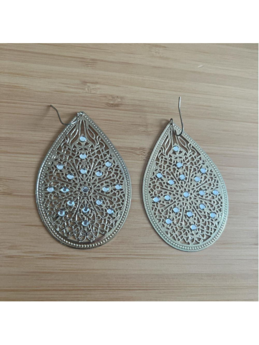 Vintage-looking gold tone earrings with silver rhinestones